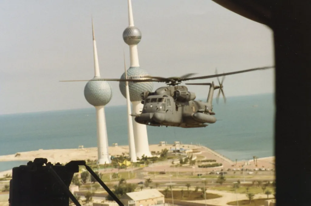 An MH-53 PAVE LOW flying past the Kuwait Towers during Desert Storm, seen from the cabin door