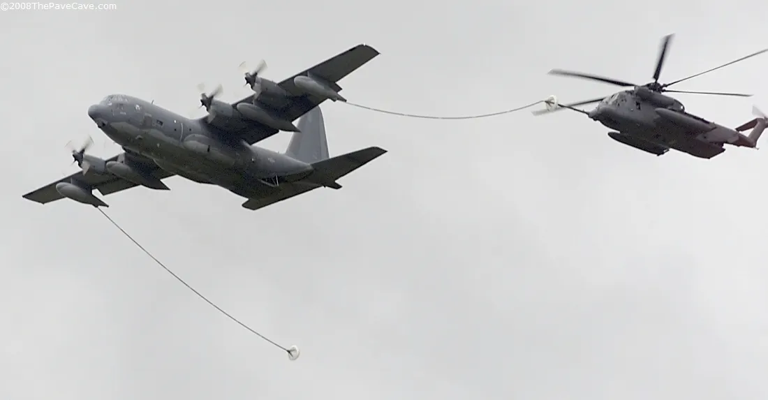 An MH-53 PAVE LOW taking fuel from an MC-130 tanker through the refueling hose